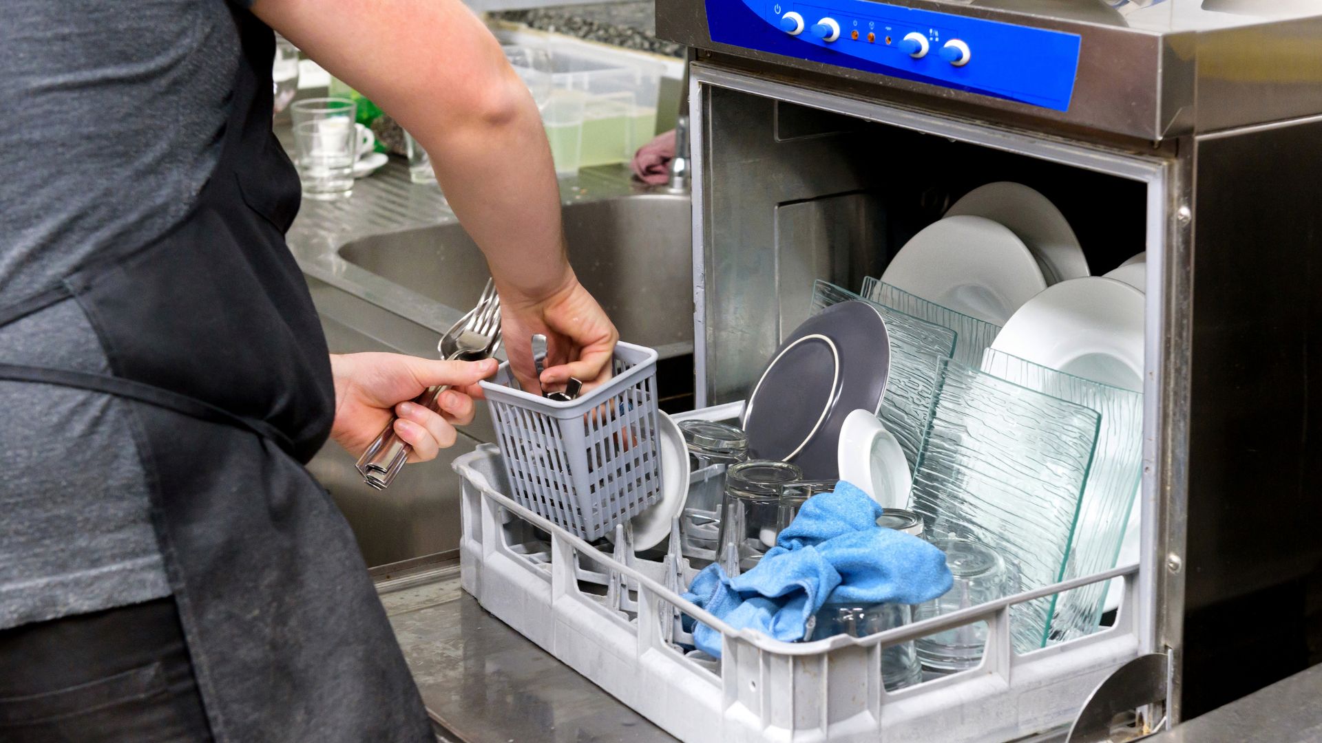 Kitchen staff cleaning the utensils and plates